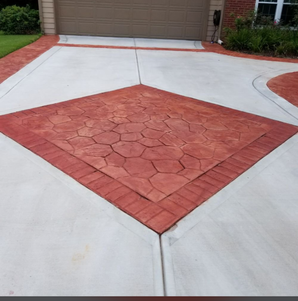 A driveway with a brick pattern in the middle