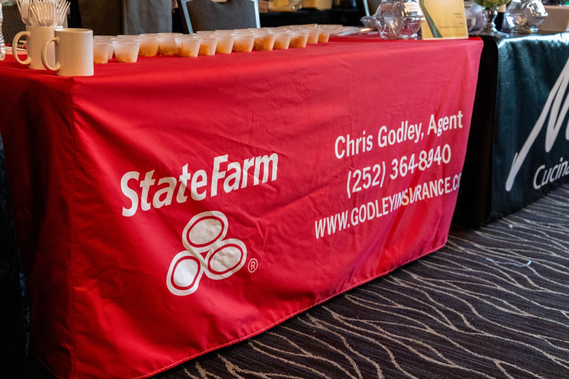 a red table cloth with state farm written on it