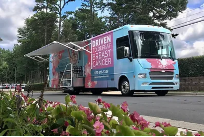 a blue and pink bus that says driven to spread breast cancer