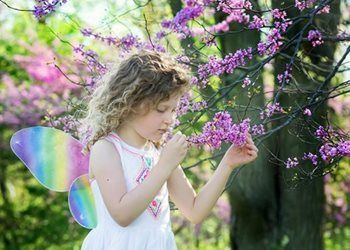 Little girl smelling a flower