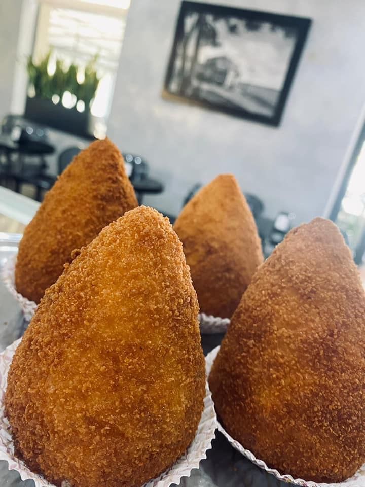 Un toast su pane rustico farcito con melanzane grigliate, pomodoro a fette, mozzarella e prosciutto crudo.