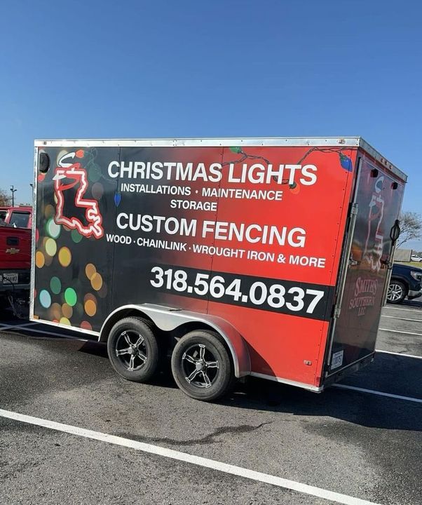 A trailer for christmas lights is parked on the side of the road.