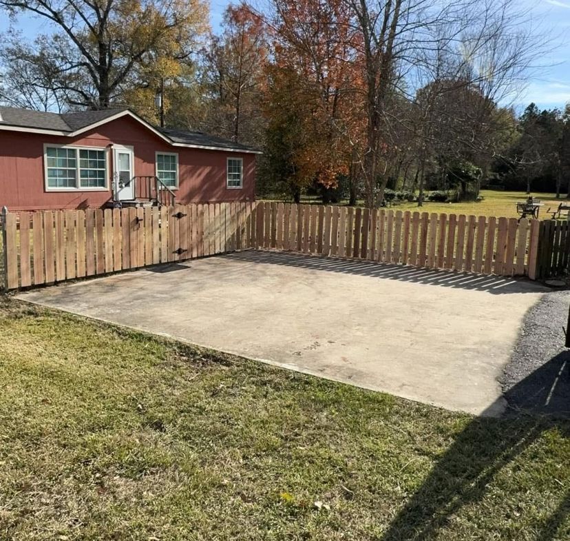 A red house with a wooden fence around it