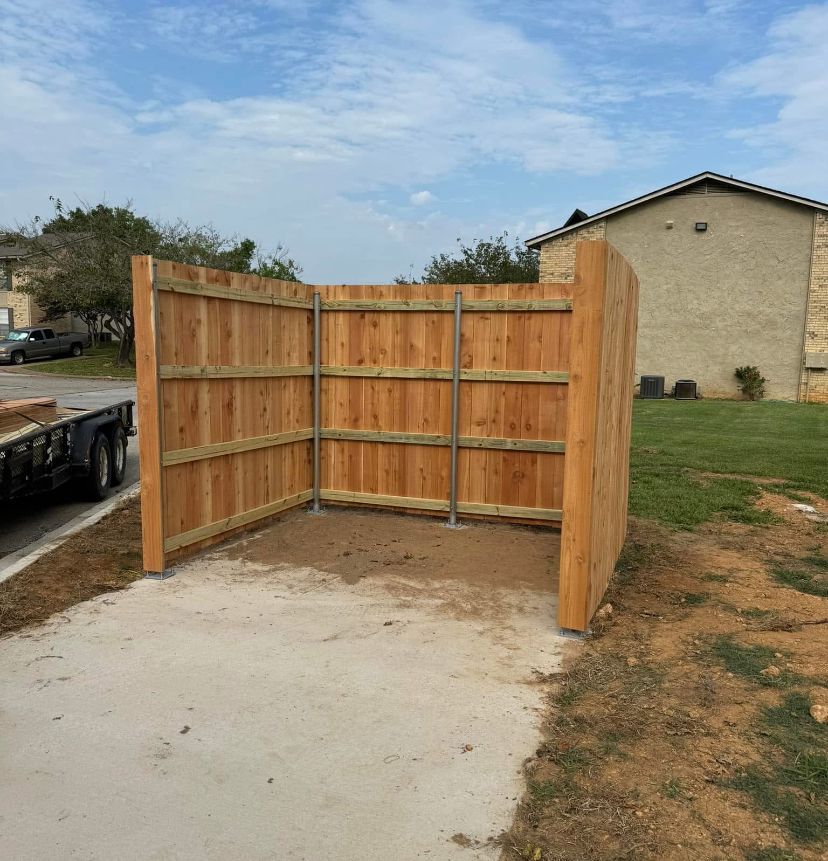 A wooden fence is being built in front of a house