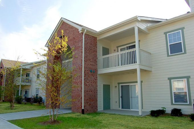 A large apartment building with a lot of windows and balconies.