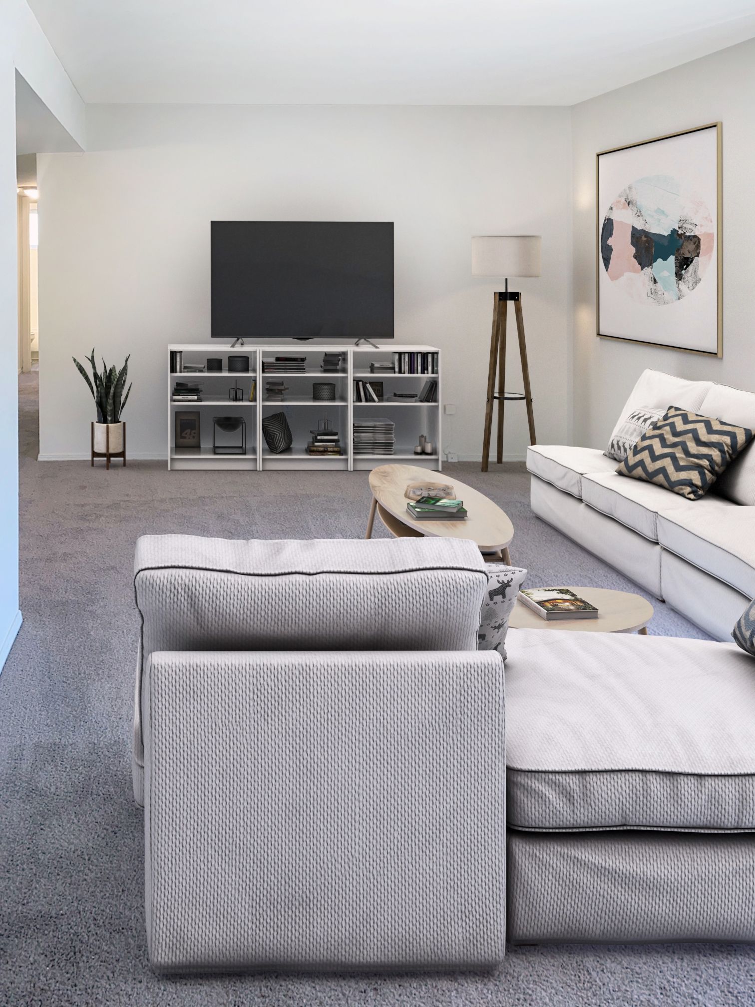 A living room with a couch , chair and television
