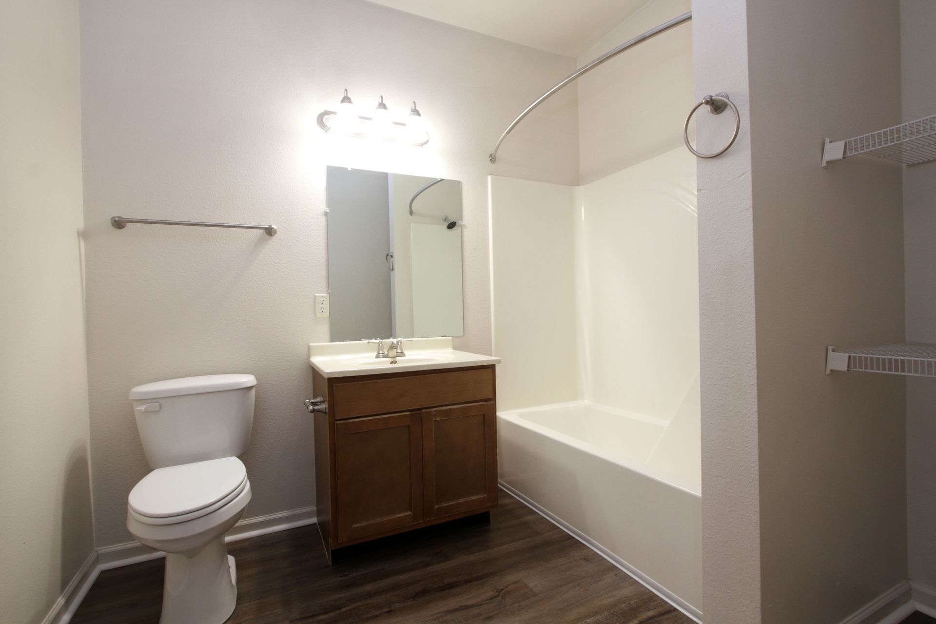 A bathroom with a toilet , sink , and bathtub.