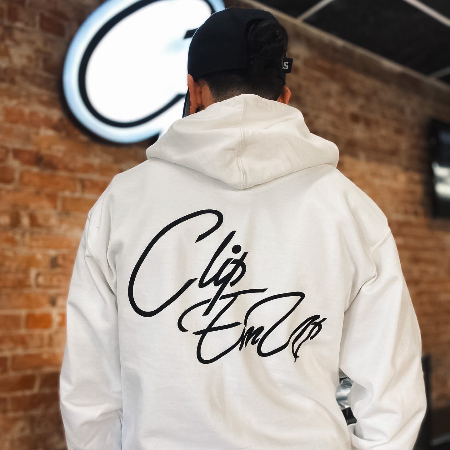 White Hoodie backside with Clip Em' Up staple logo