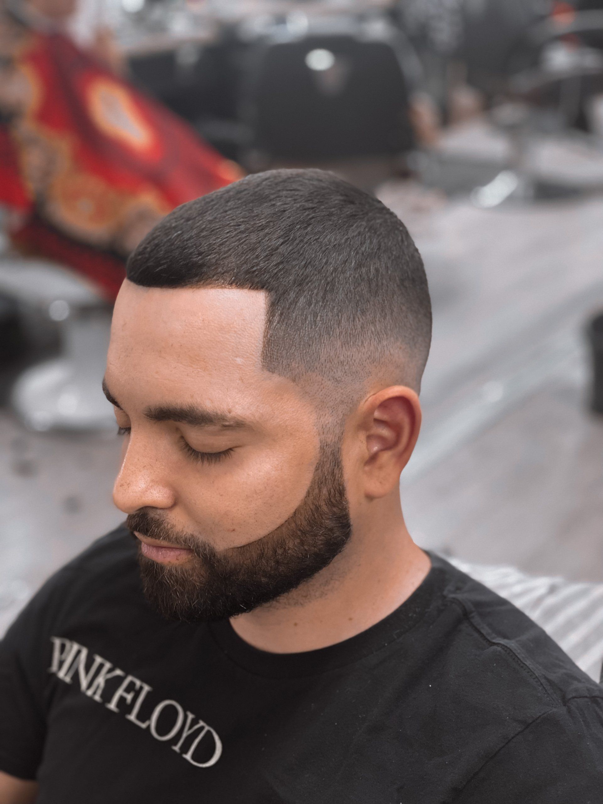 Gio lining up clients beard with razor