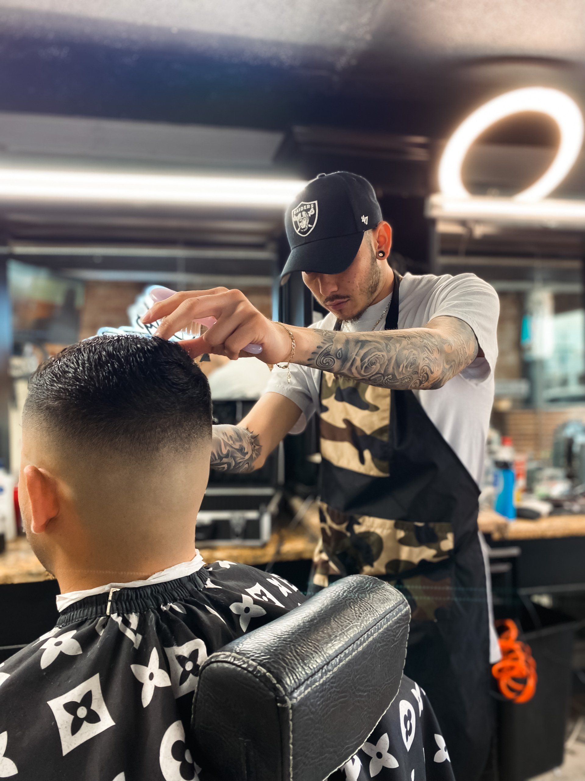 Nick barber at Clip Em' Up using clippers cutting hair