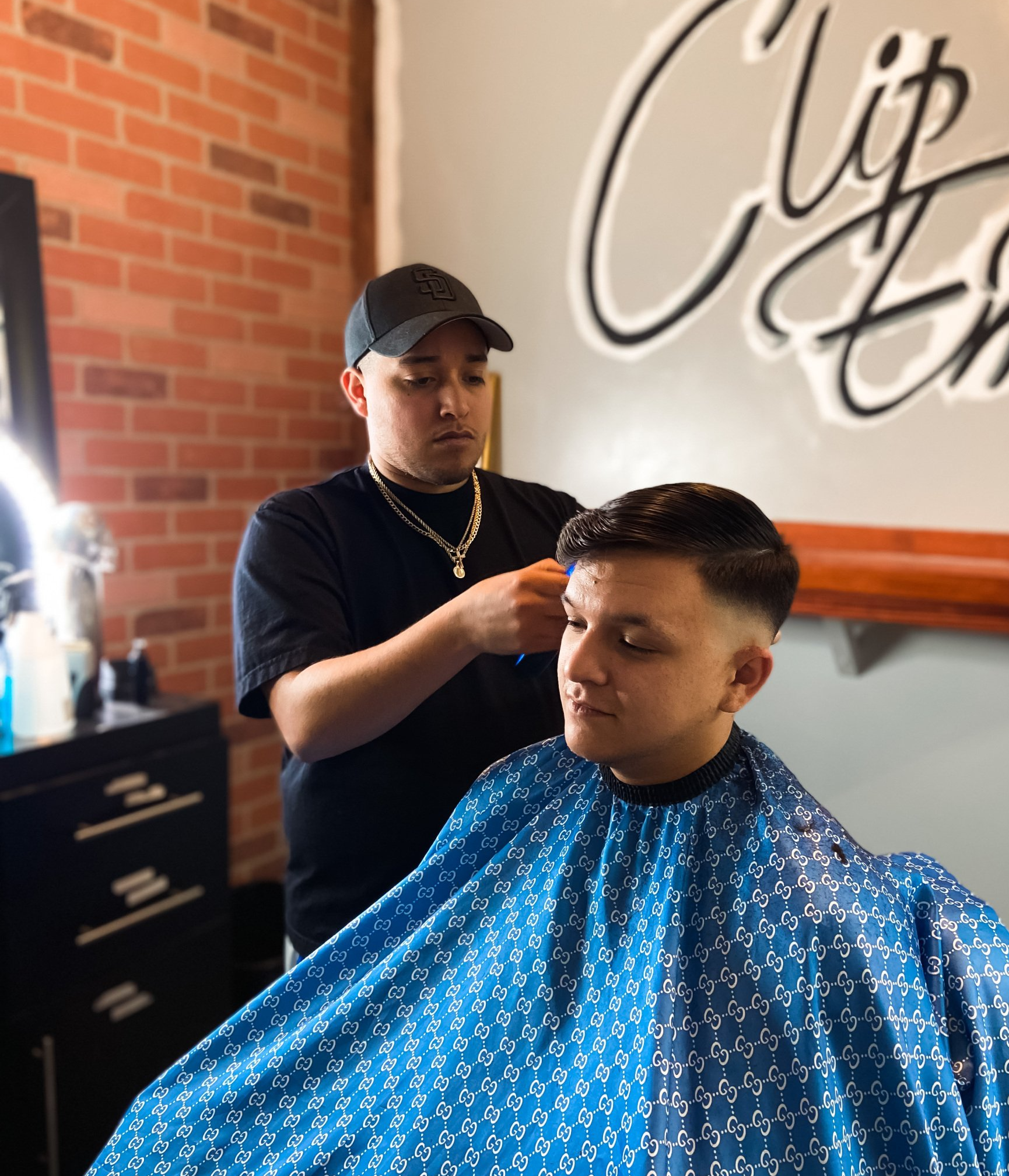 Seth giving haircut at Clip Em' Up