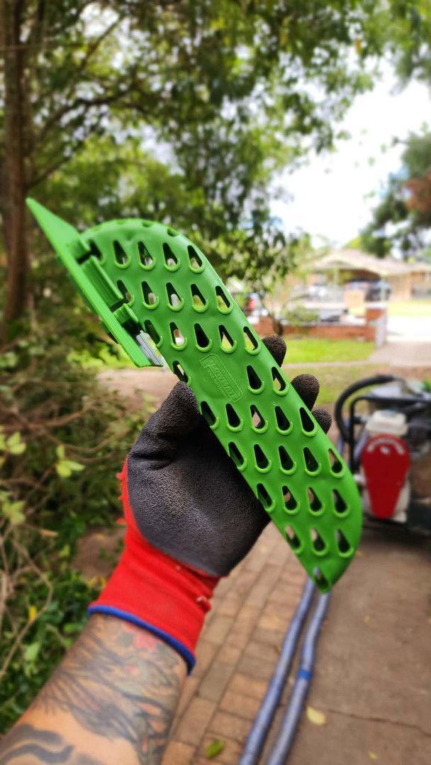 Blue-handled Gutter Cleaner Removing Debris From a Black Gutter — Rapid Rinse Solutions in Shepparton, VIC