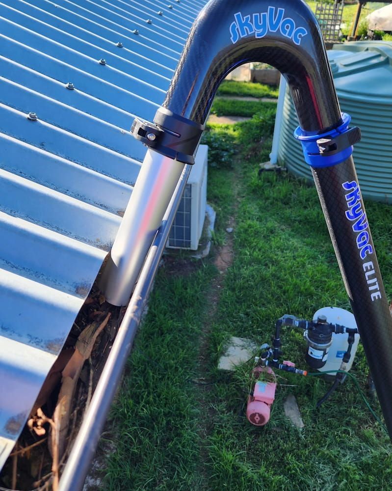 A Person Uses a Skyvac Gutter Cleaning System — Rapid Rinse Solutions in Katunga, VIC