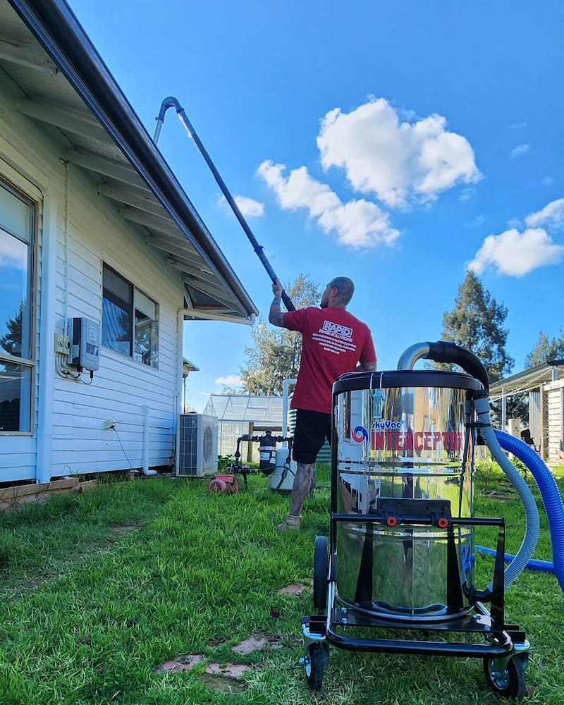 Man Cleaning Gutters With a Vacuum and Long Hose — Rapid Rinse Solutions in Katunga, VIC