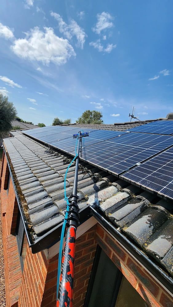Person Using a Pole to Clean Solar Panels on a Roof — Rapid Rinse Solutions in Katunga, VIC
