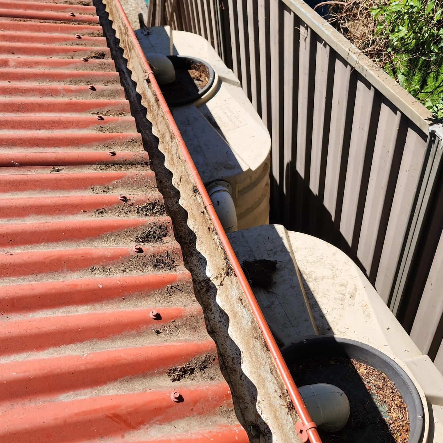 Red Corrugated Roof With Guttering and Rainwater Tanks — Rapid Rinse Solutions in Tatura, VIC
