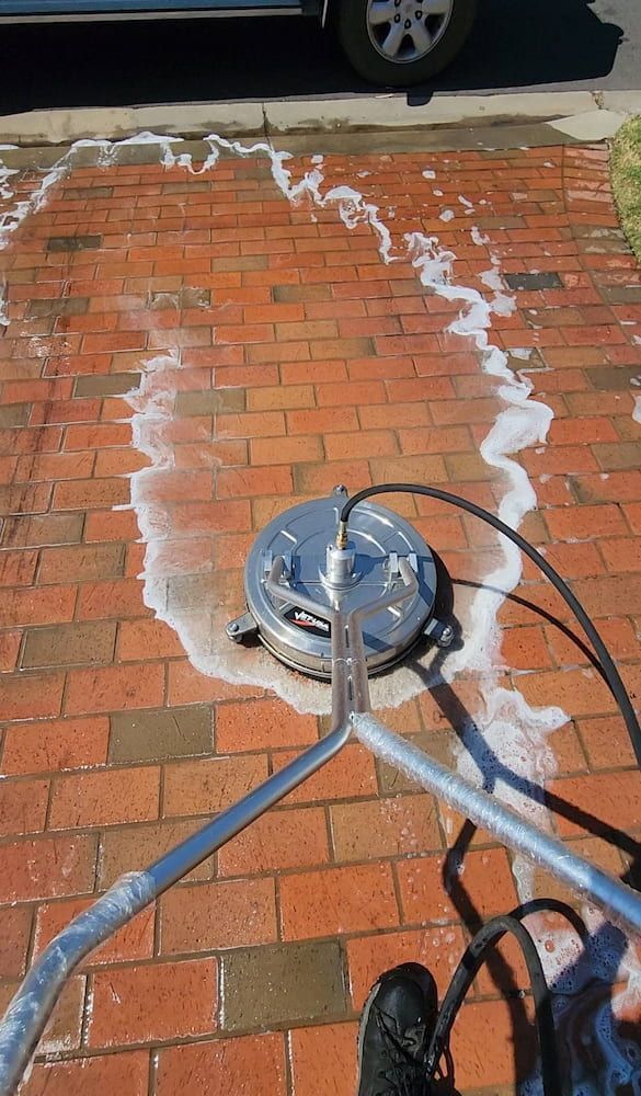 Power Washer Cleaning Red Brick Driveway, Creating Foamy Water Trails — Rapid Rinse Solutions in Katunga, VIC