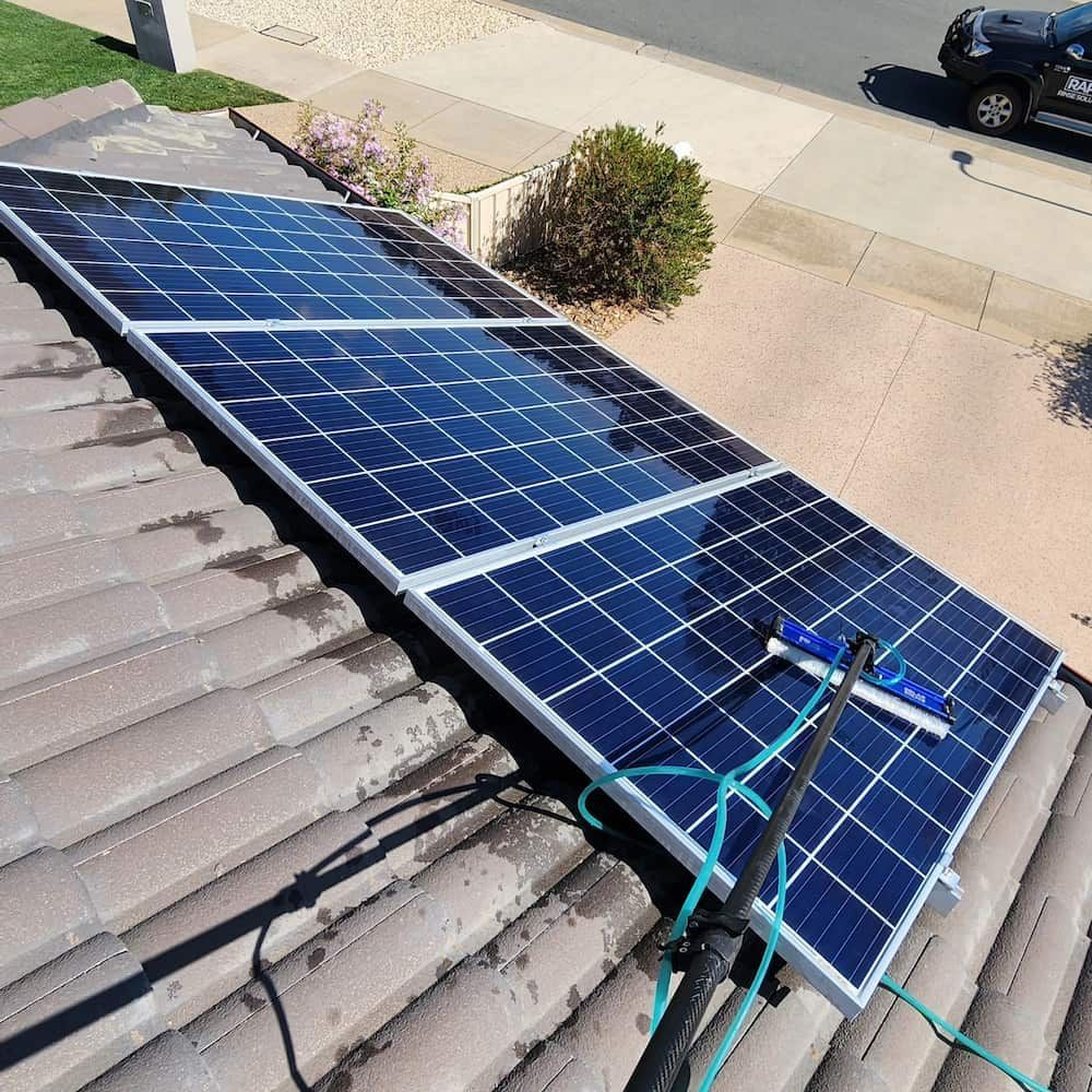 Solar Panels on a Red-tiled Roof Being Cleaned — Rapid Rinse Solutions in Mooroopna, VIC