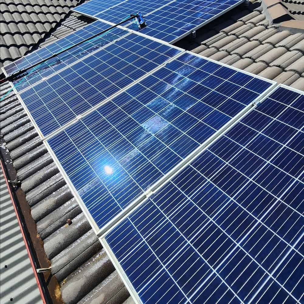 Solar Panels Installed on a Gray Tiled Roof, Capturing Sunlight — Rapid Rinse Solutions in Mooroopna, VIC