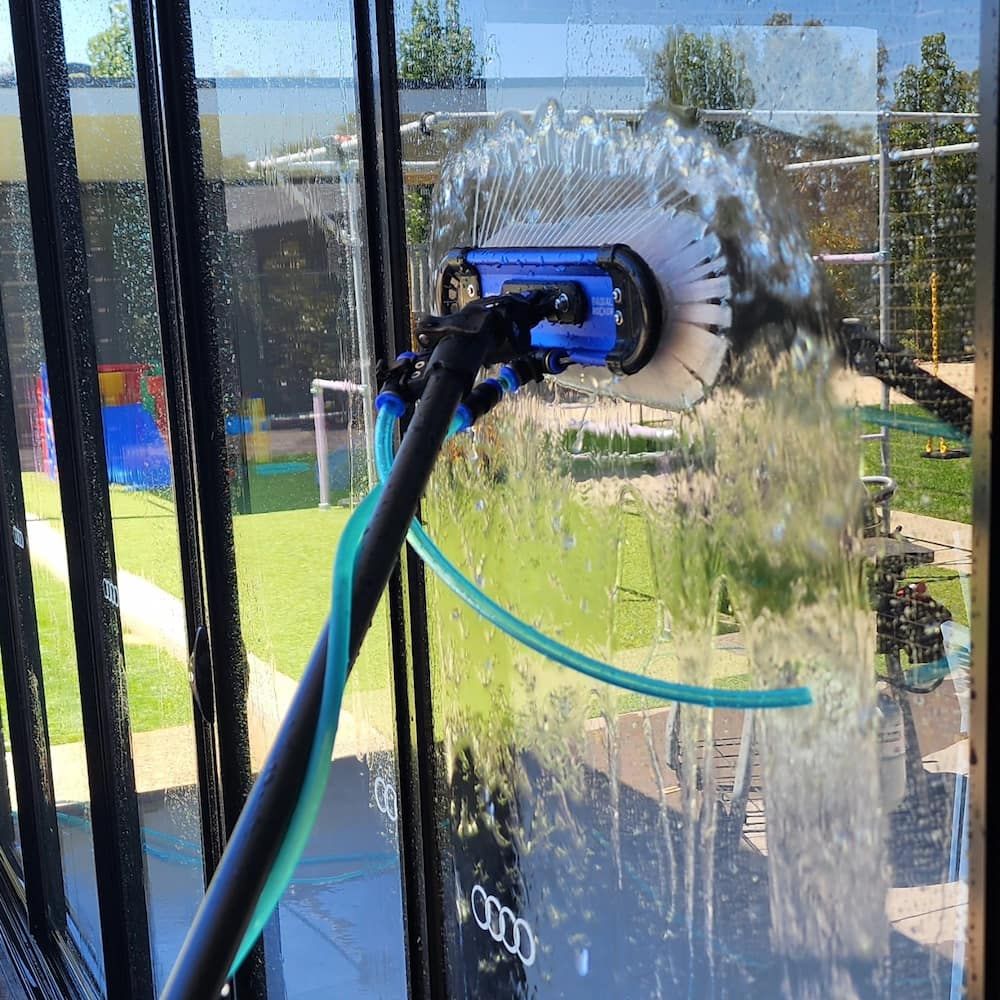 Window Being Cleaned With a Long-handled Brush — Rapid Rinse Solutions in Katunga, VIC