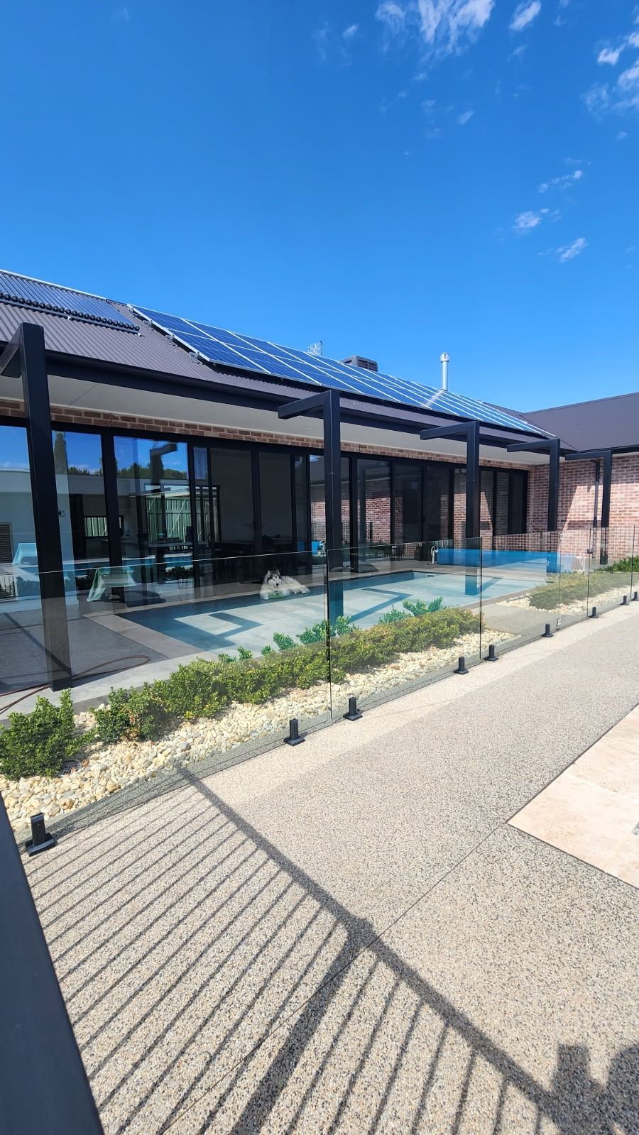 Man Cleaning Window With Long Brush — Rapid Rinse Solutions in Shepparton, VIC