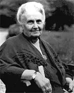 A black and white photo of an elderly woman sitting in a chair.