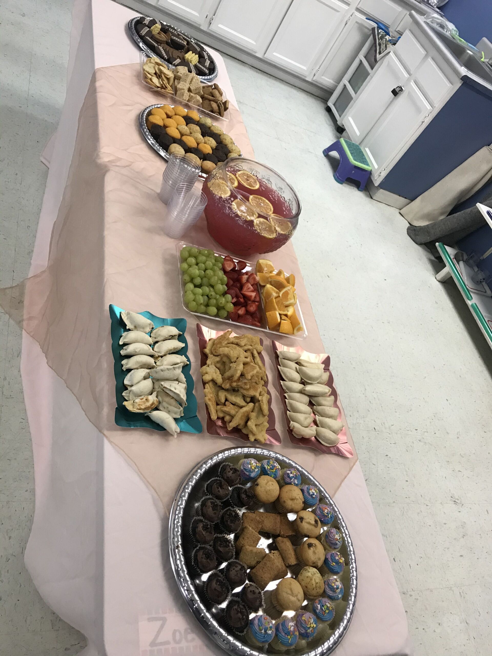 A long table with a variety of food on it