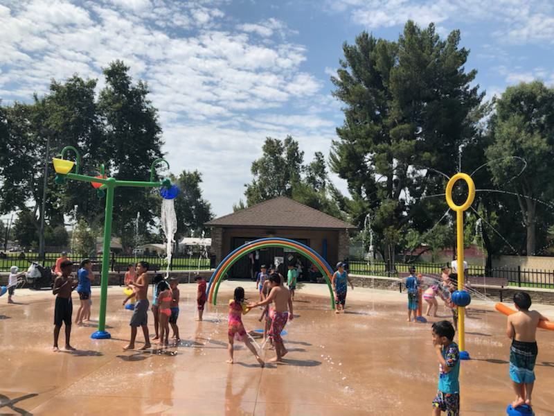 A group of children are playing in a water park.