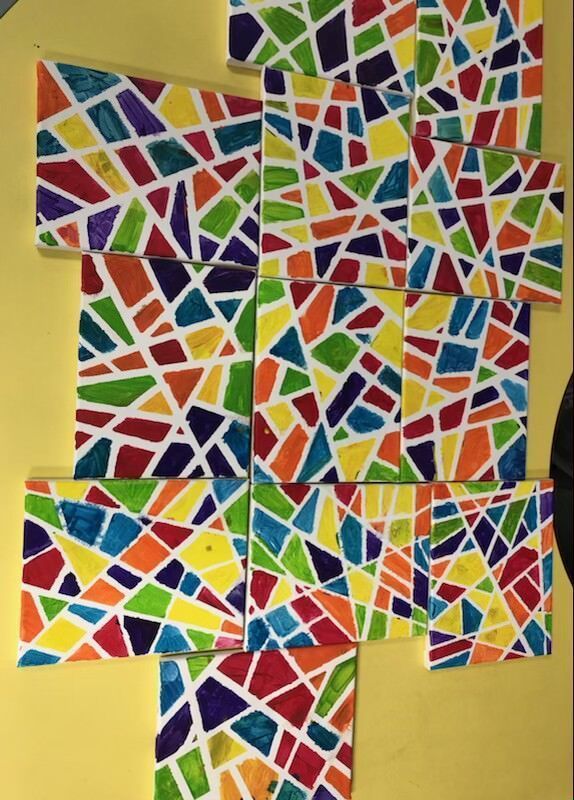 A bunch of colorful pieces of paper on a yellow background