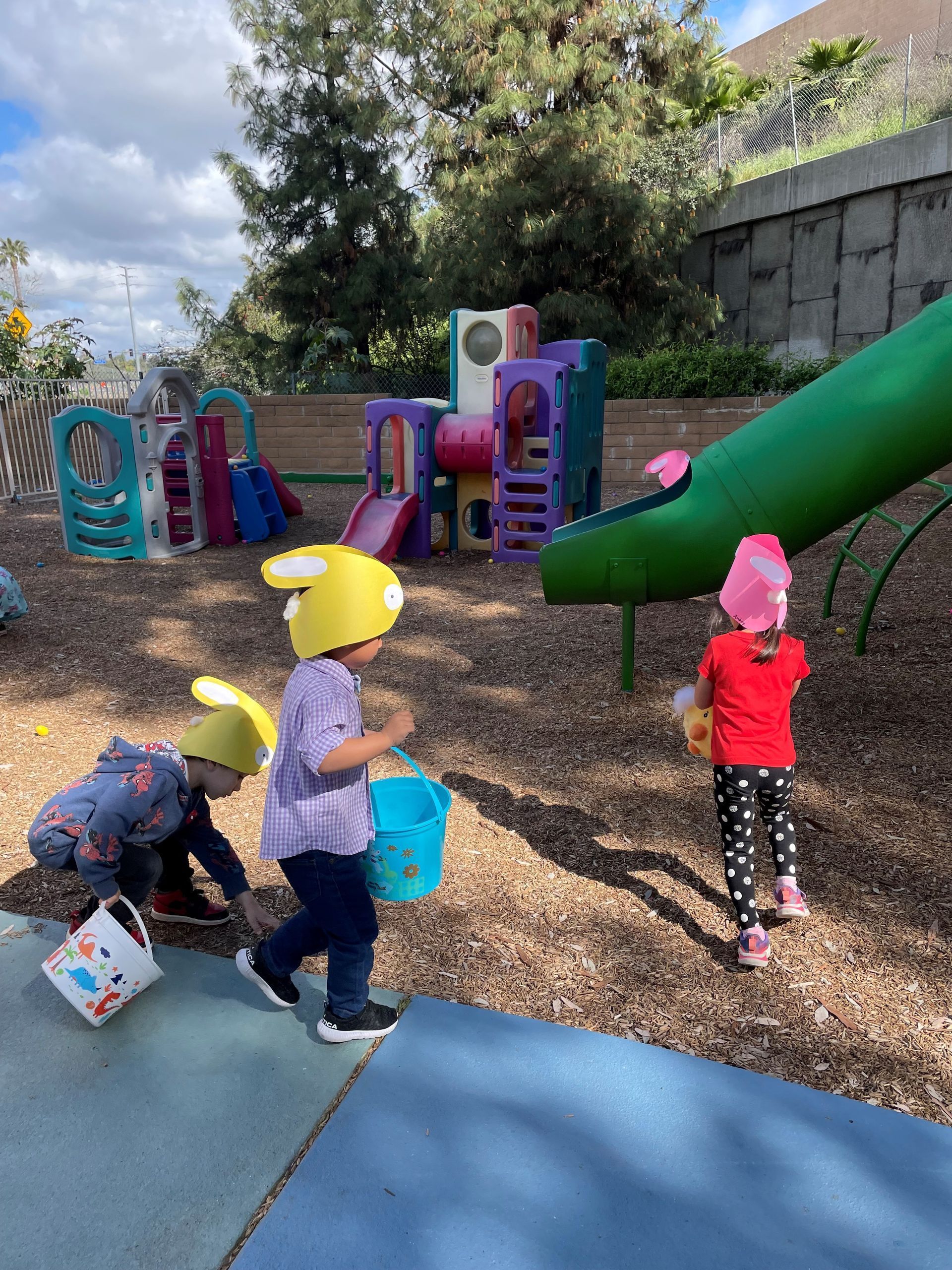 A group of children are playing in a playground.