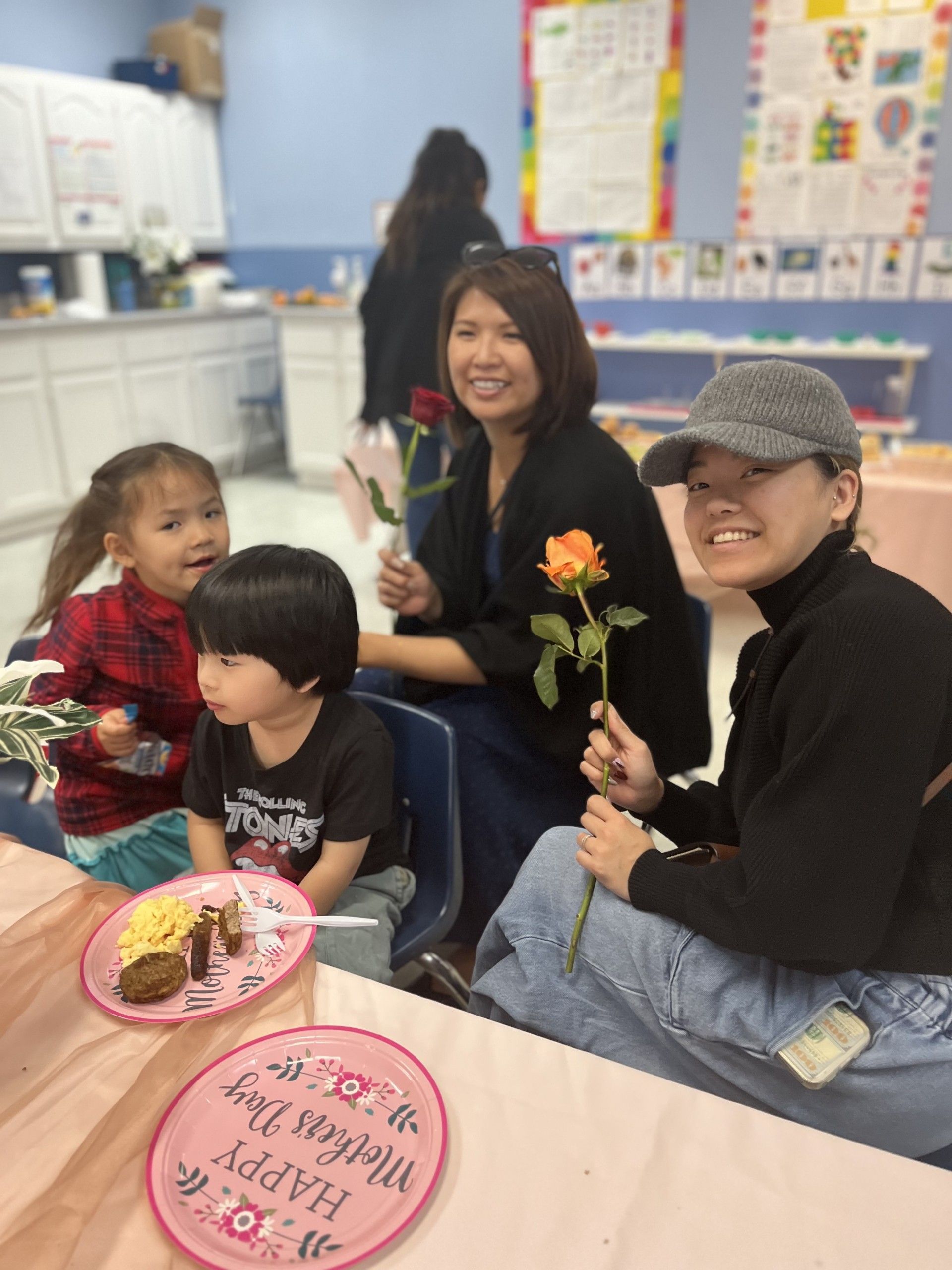 A group of people are sitting at a table with plates of food.