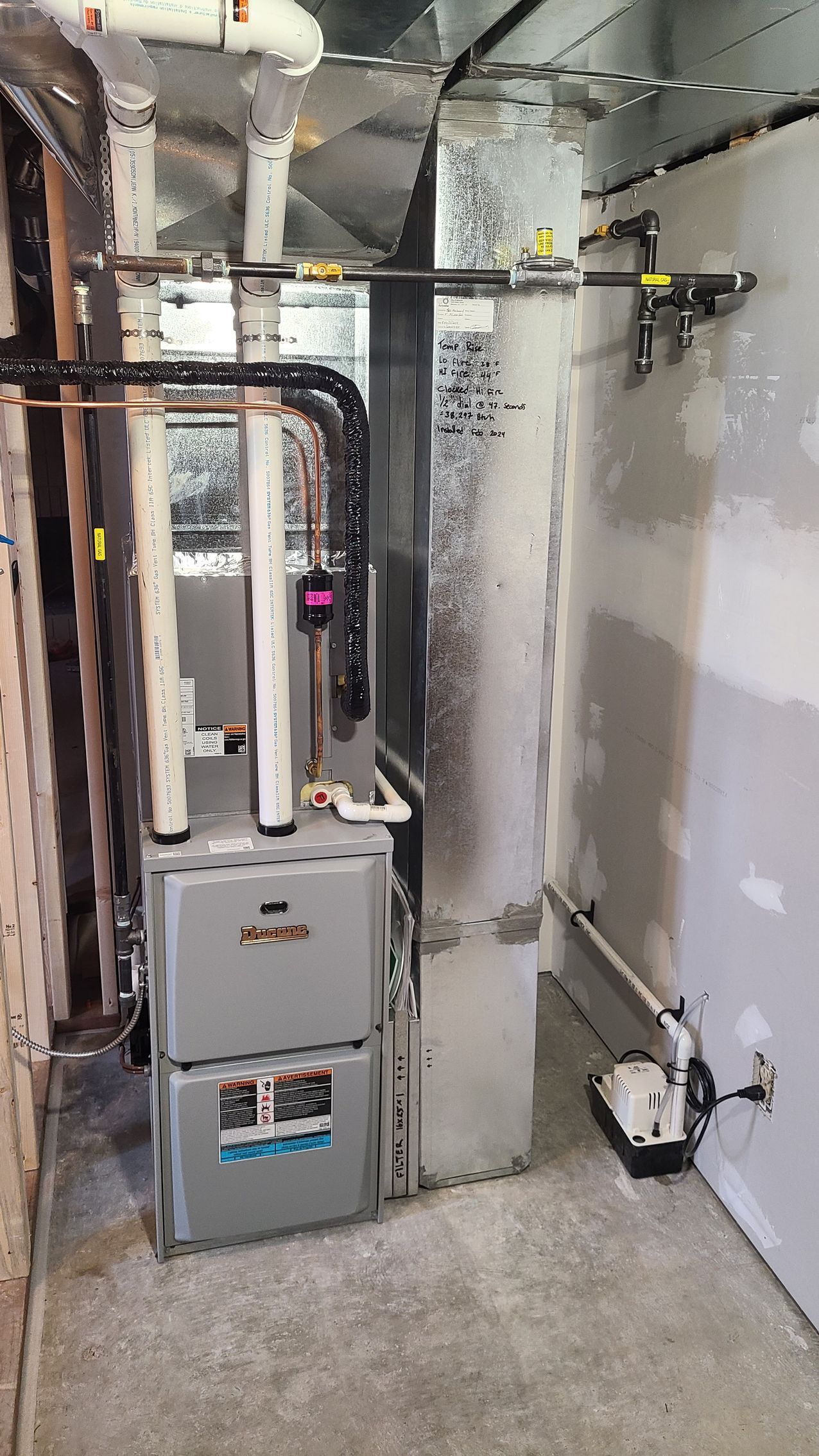 A room with a heater and pipes in it.