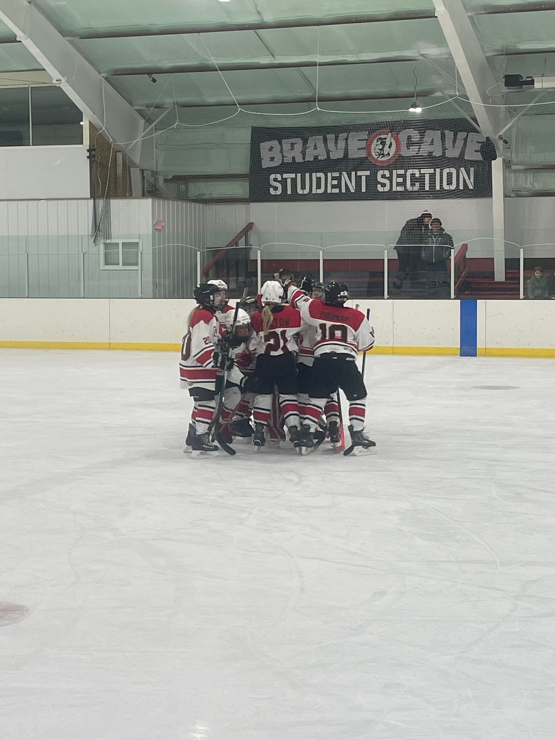 Baseball player sliding into home plate, catcher in front. Blue and gold uniforms, action shot.