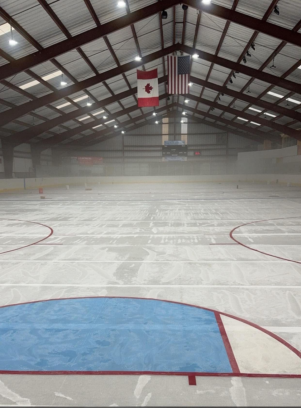Baseball player sliding into base as another player attempts to catch the ball.