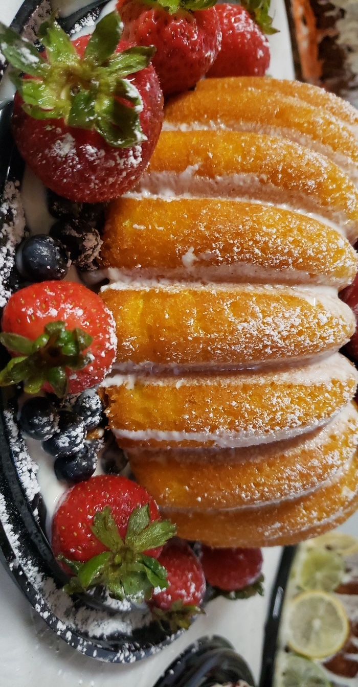 A close up of a plate of food with strawberries and blueberries on it.