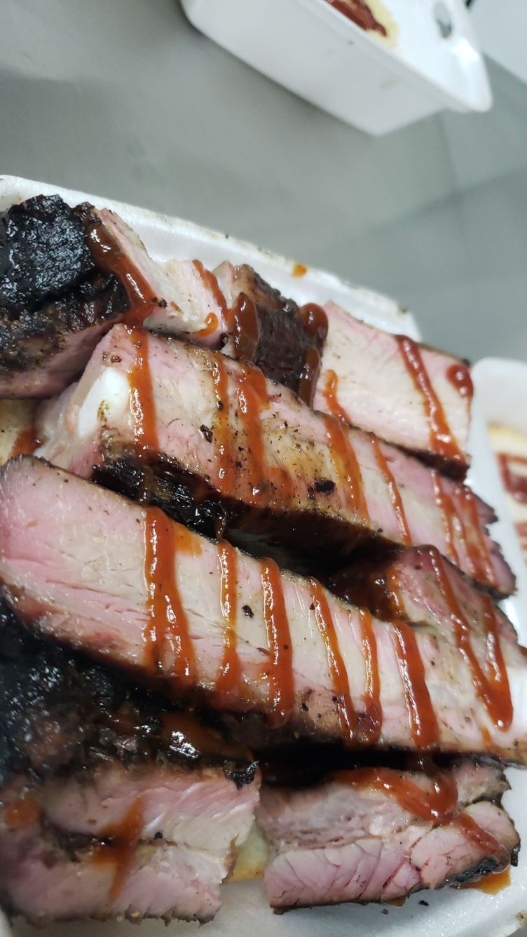 A close up of a plate of meat with sauce on it