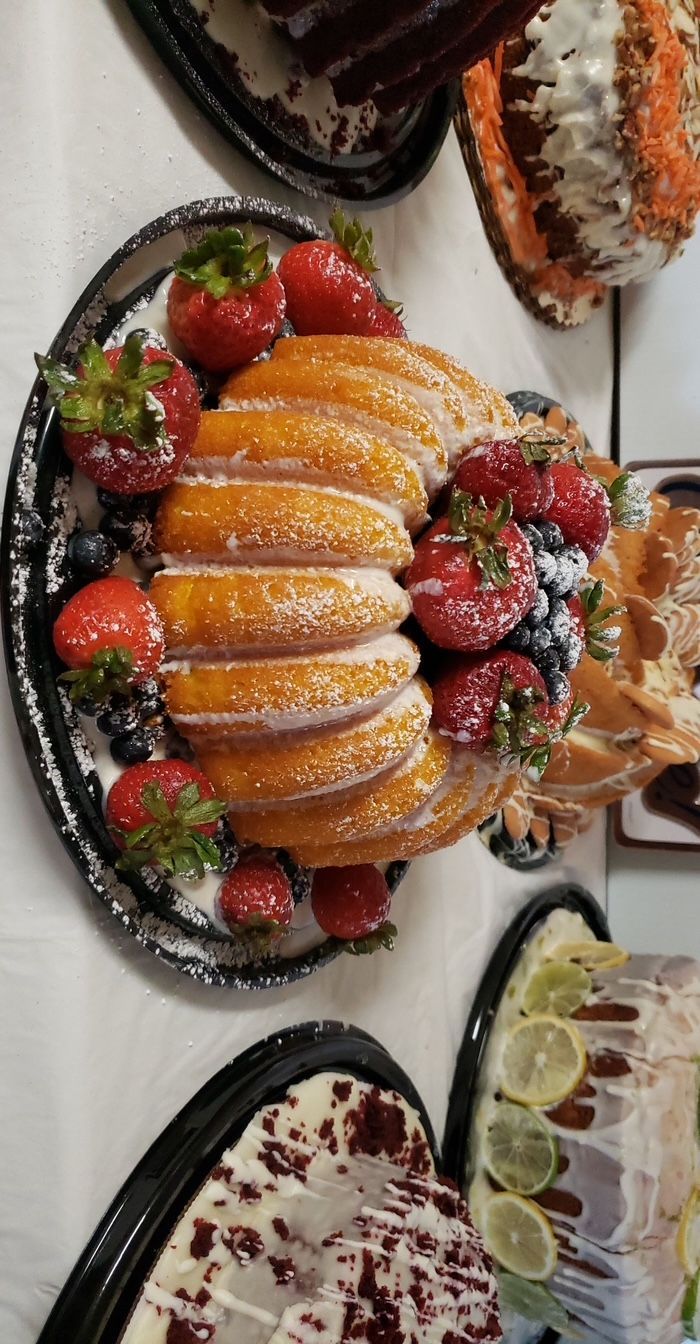 There are many different types of cakes on the table.