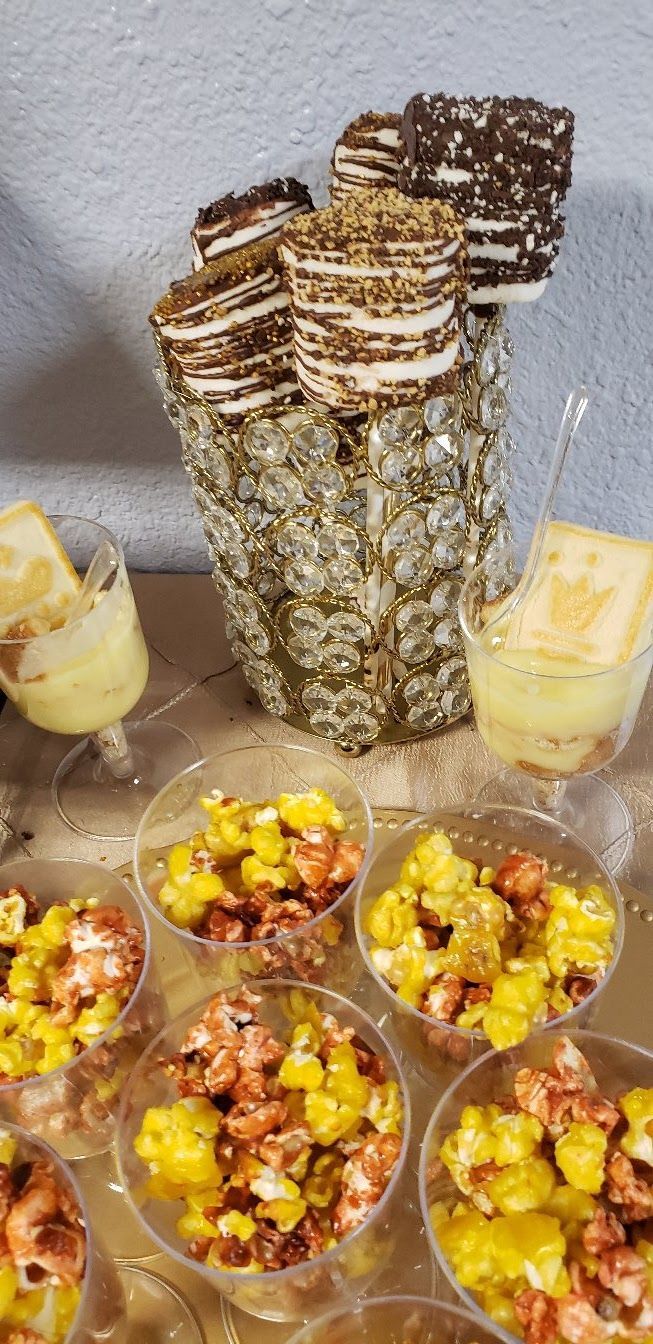 A table topped with a variety of desserts and popcorn.