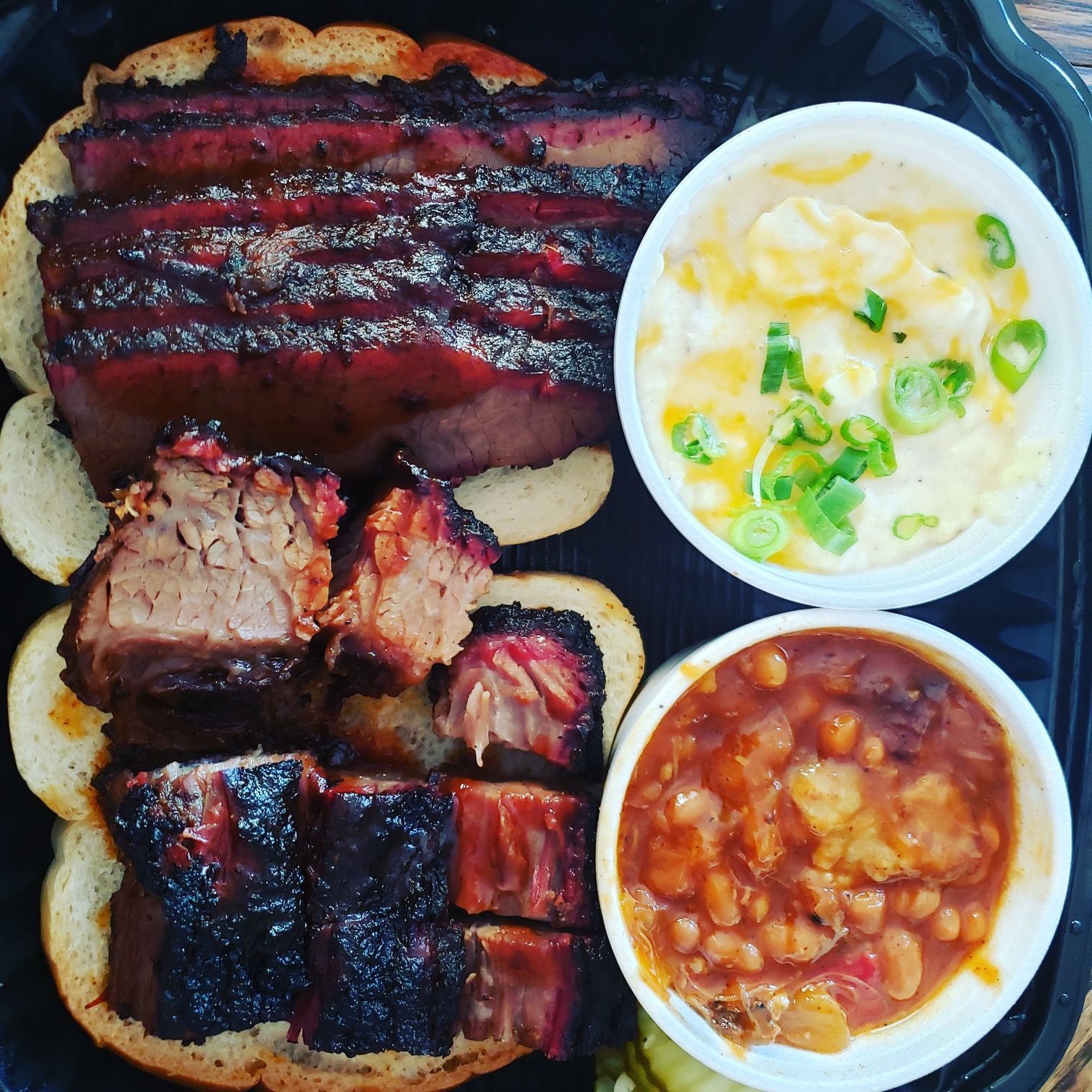 A plate of food with meat beans and mashed potatoes