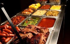 A buffet line filled with lots of different types of food.