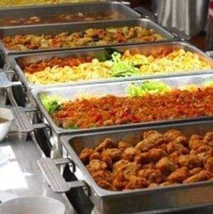 A buffet line filled with lots of different types of food.