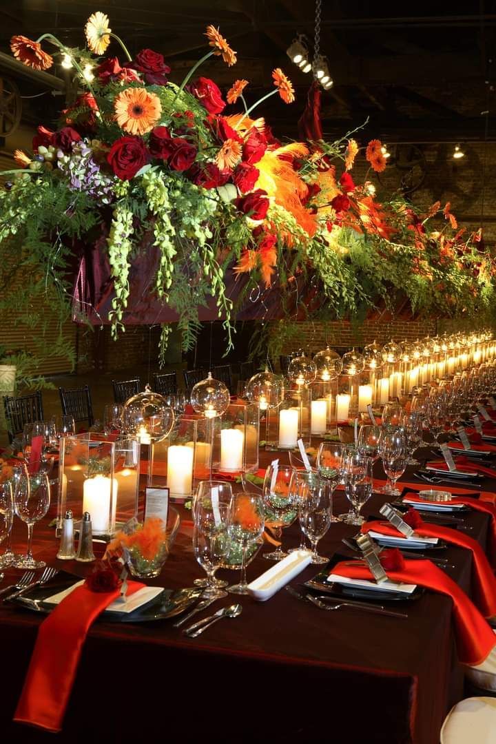 A long table with candles and flowers on it.