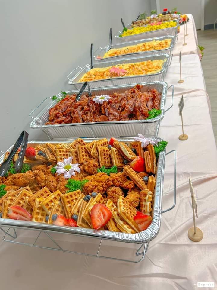 A buffet table with a variety of food on it.