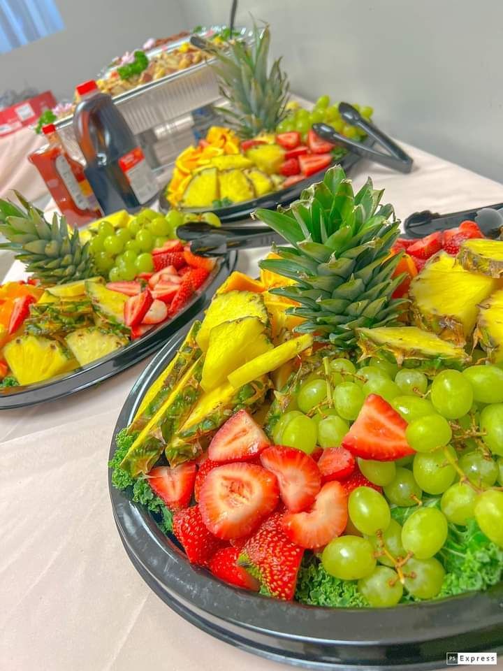 A table topped with plates of fruit and vegetables.