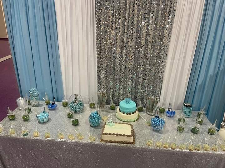 A table with a cake and candy on it.