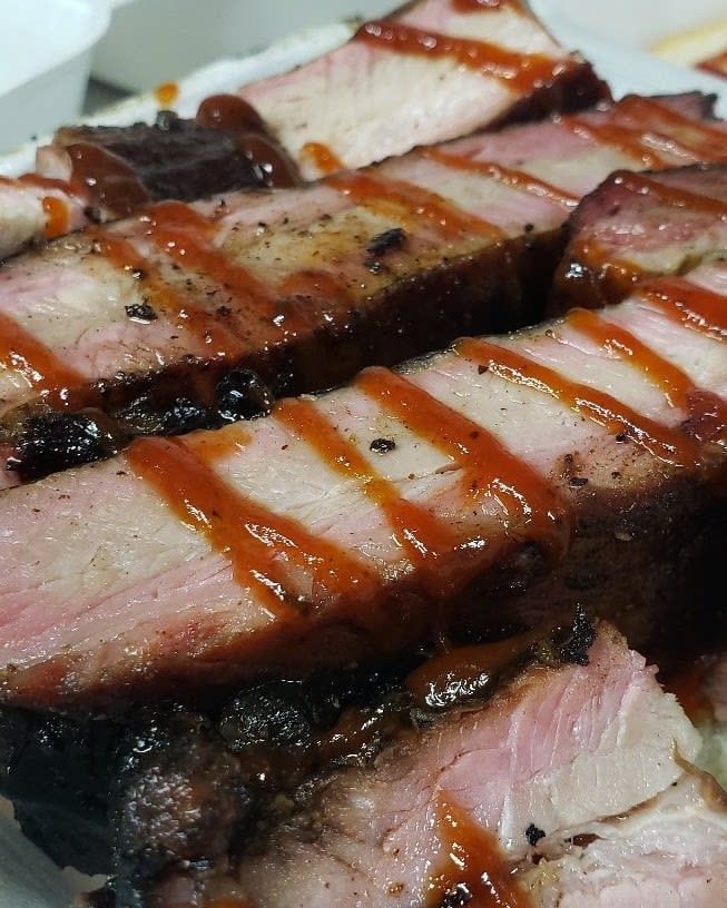 A close up of a piece of meat with sauce on it