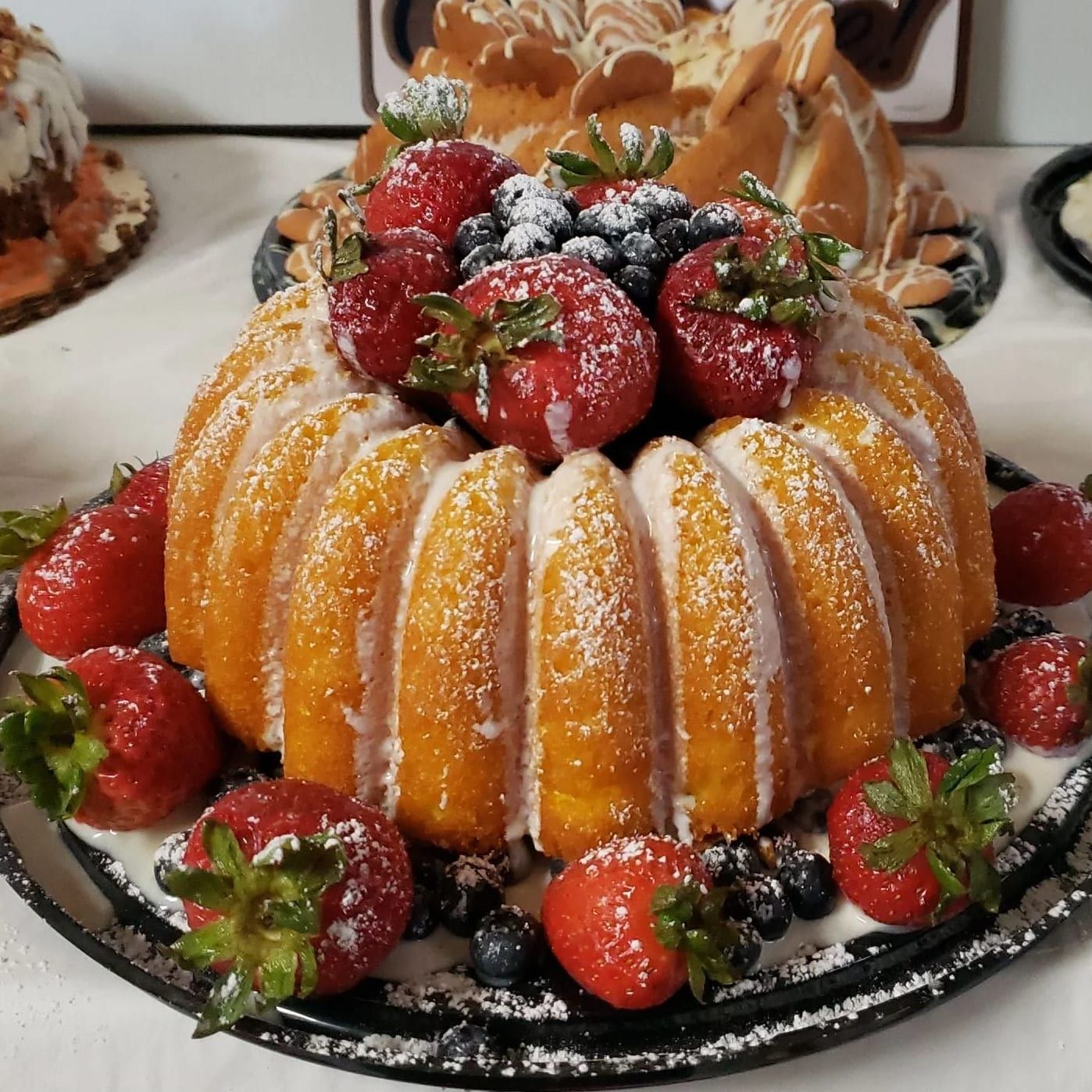 A bundt cake with strawberries and blueberries on top
