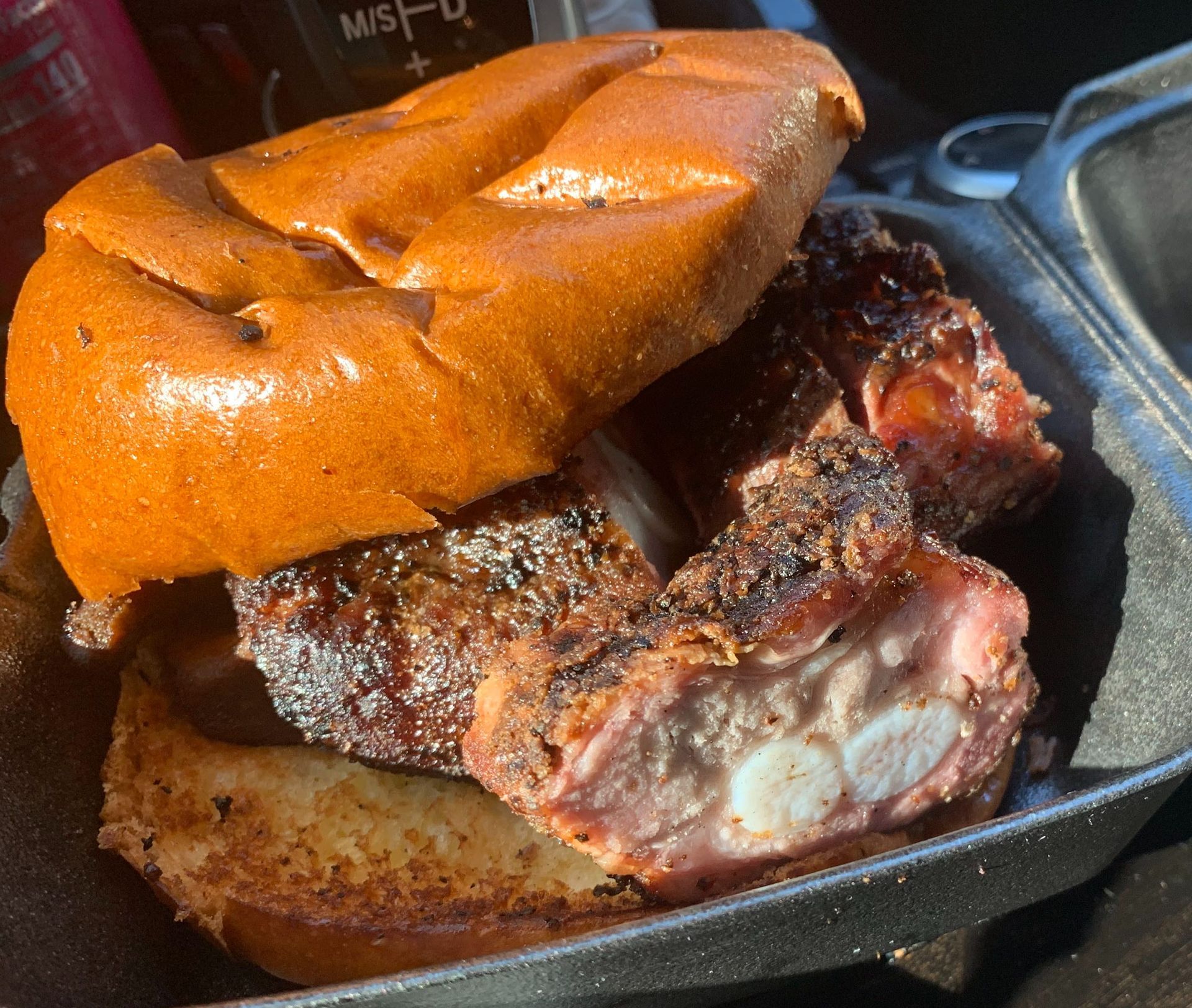 A close up of a sandwich with meat on a bun