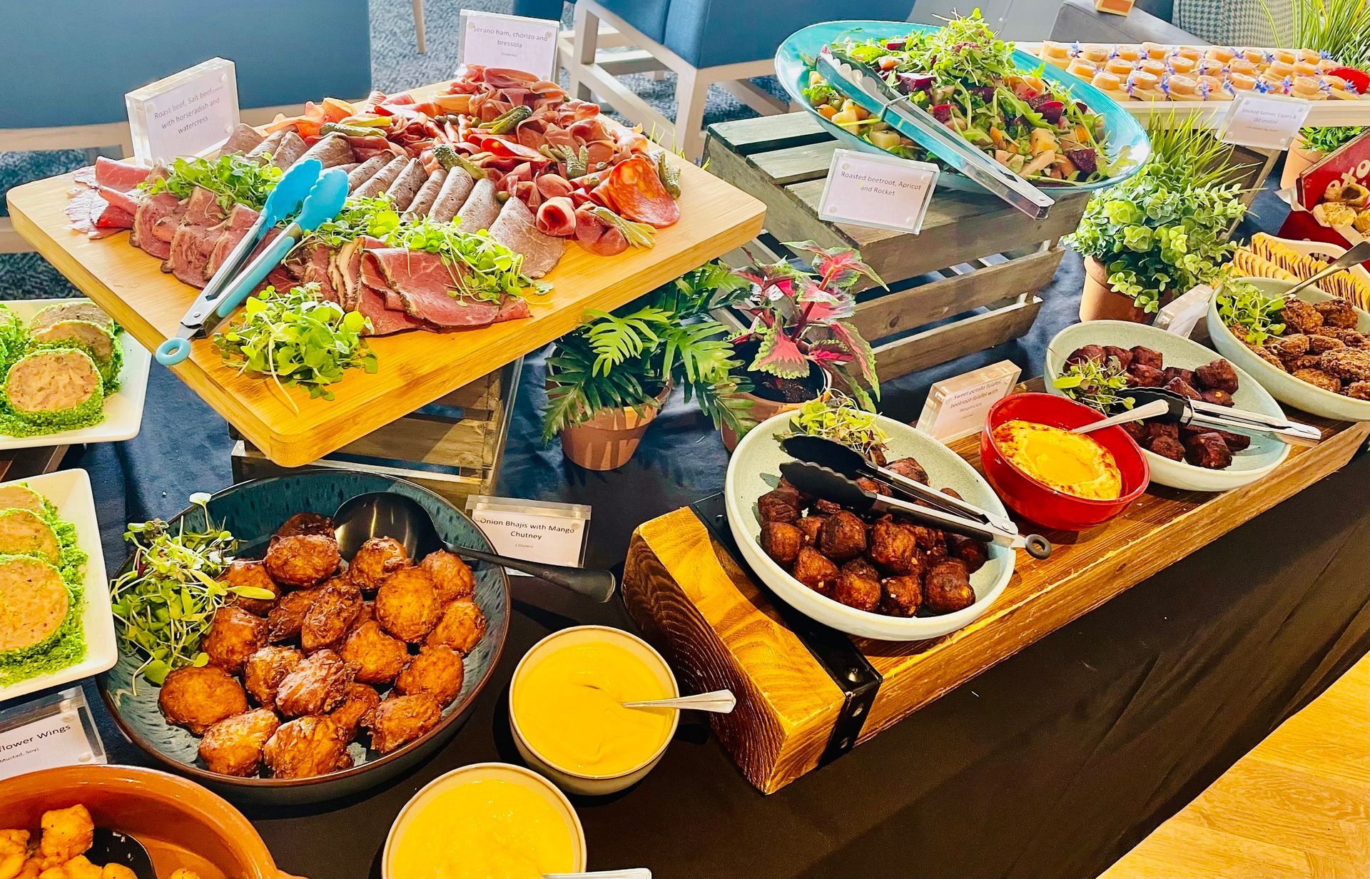 Buffet table with various dishes: meats, salads, and sides.