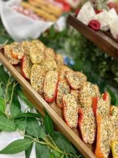 Tray of stuffed mini bell peppers with breadcrumb topping.